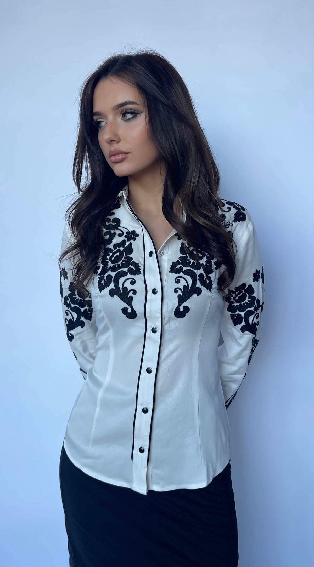 Model in the H Bar C Fort Worth white western shirt with black silk chain stitch roses.