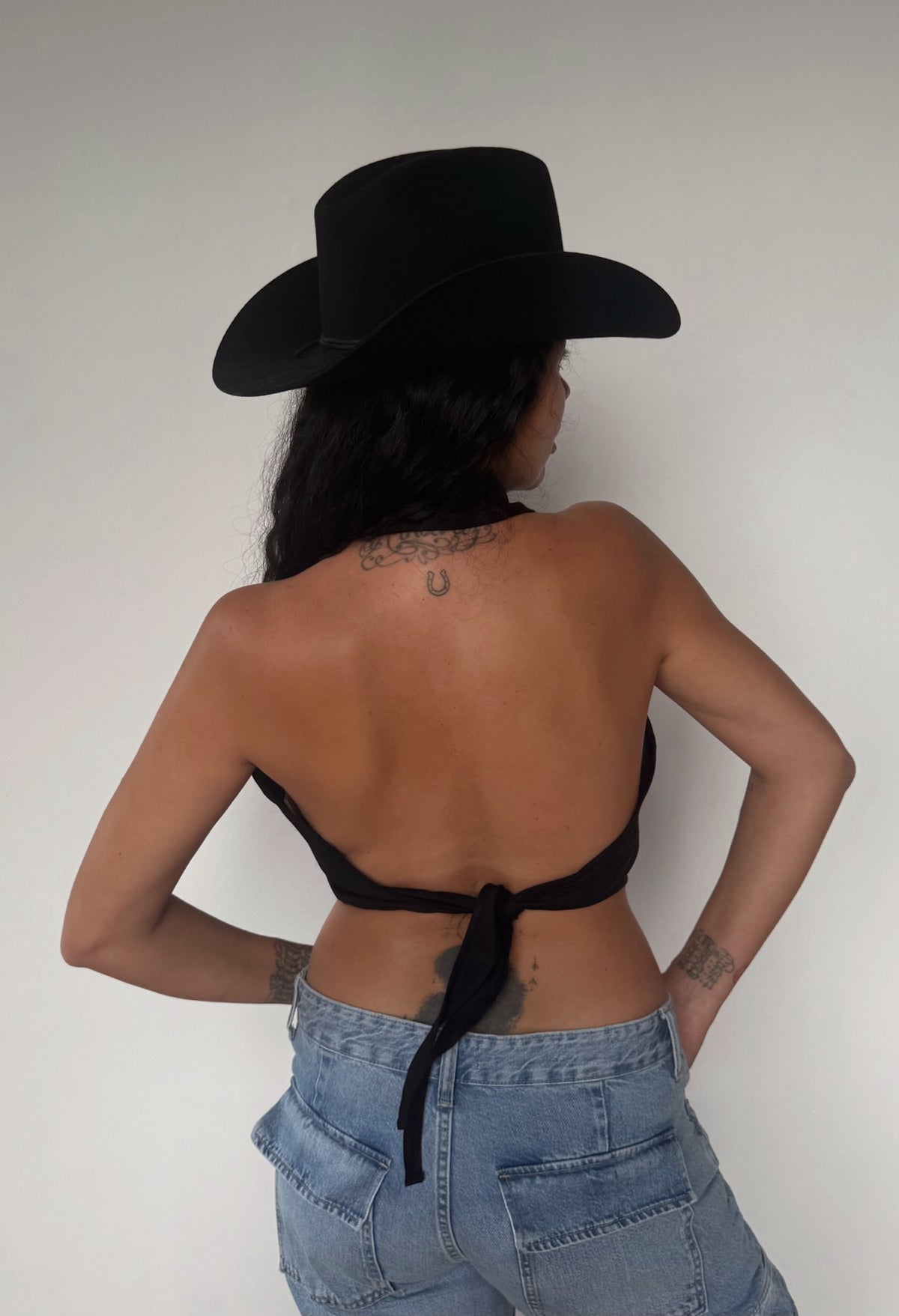 Open back detail of the H Bar C Hampton black halter top with tie at the waist.