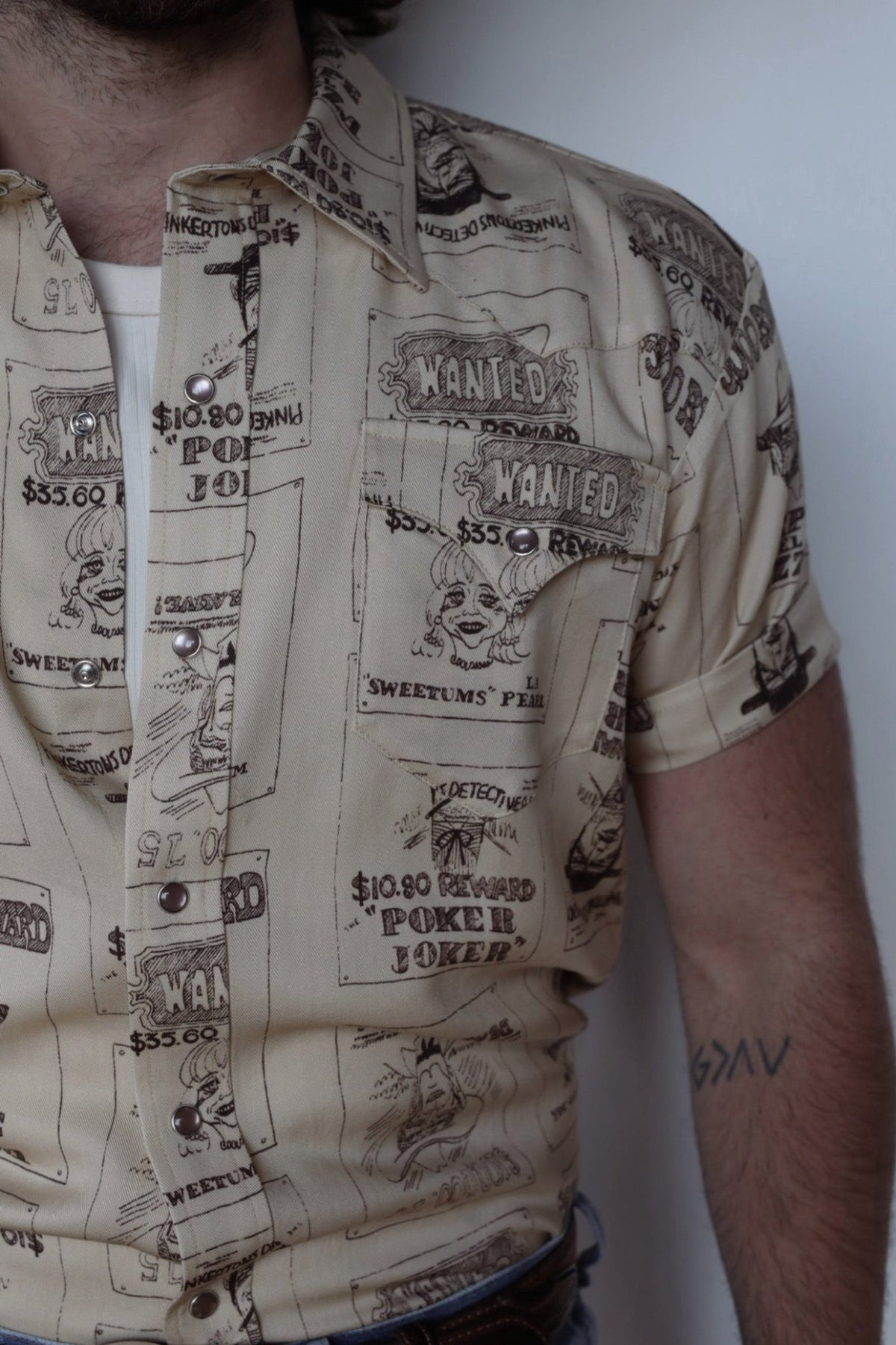 Close-up of the brown western novelty print and pearl snaps on the H Bar C Newport Tumbleweed shirt.