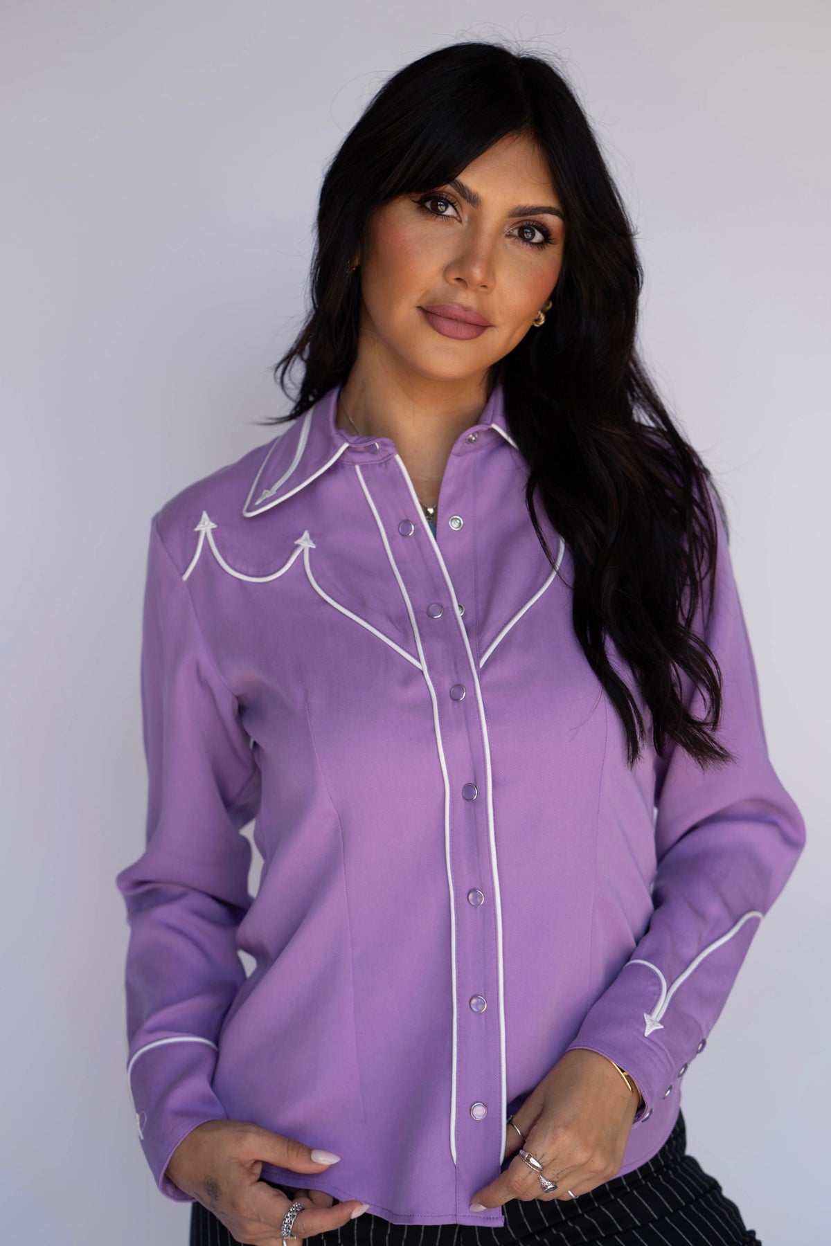Woman wearing the H Bar C Lake Tahoe women's shirt in lavender with white piping and pearl snaps.