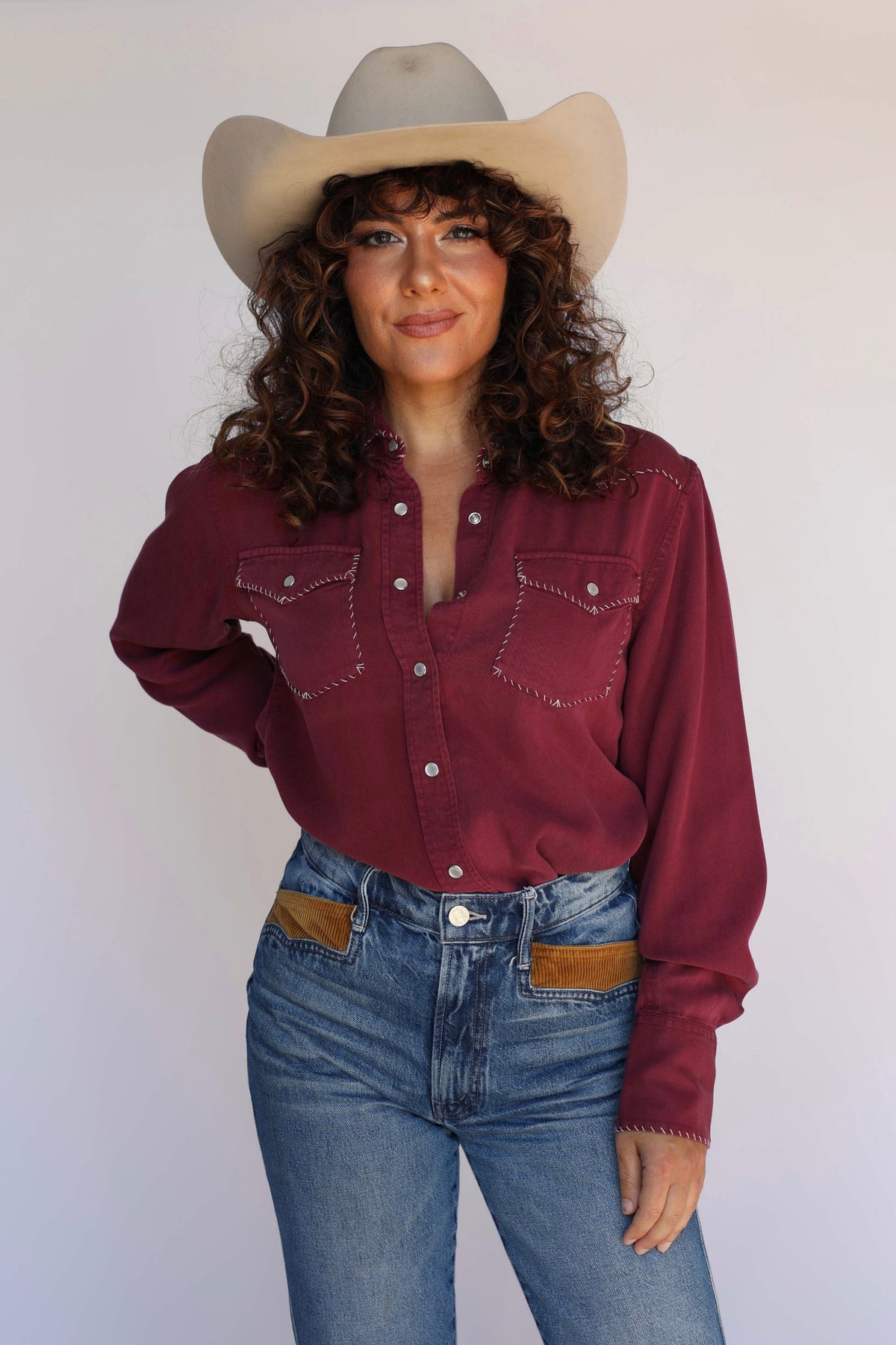 Woman with hand on hip in the H Bar C Brooklyn wine western shirt and cowboy hat.