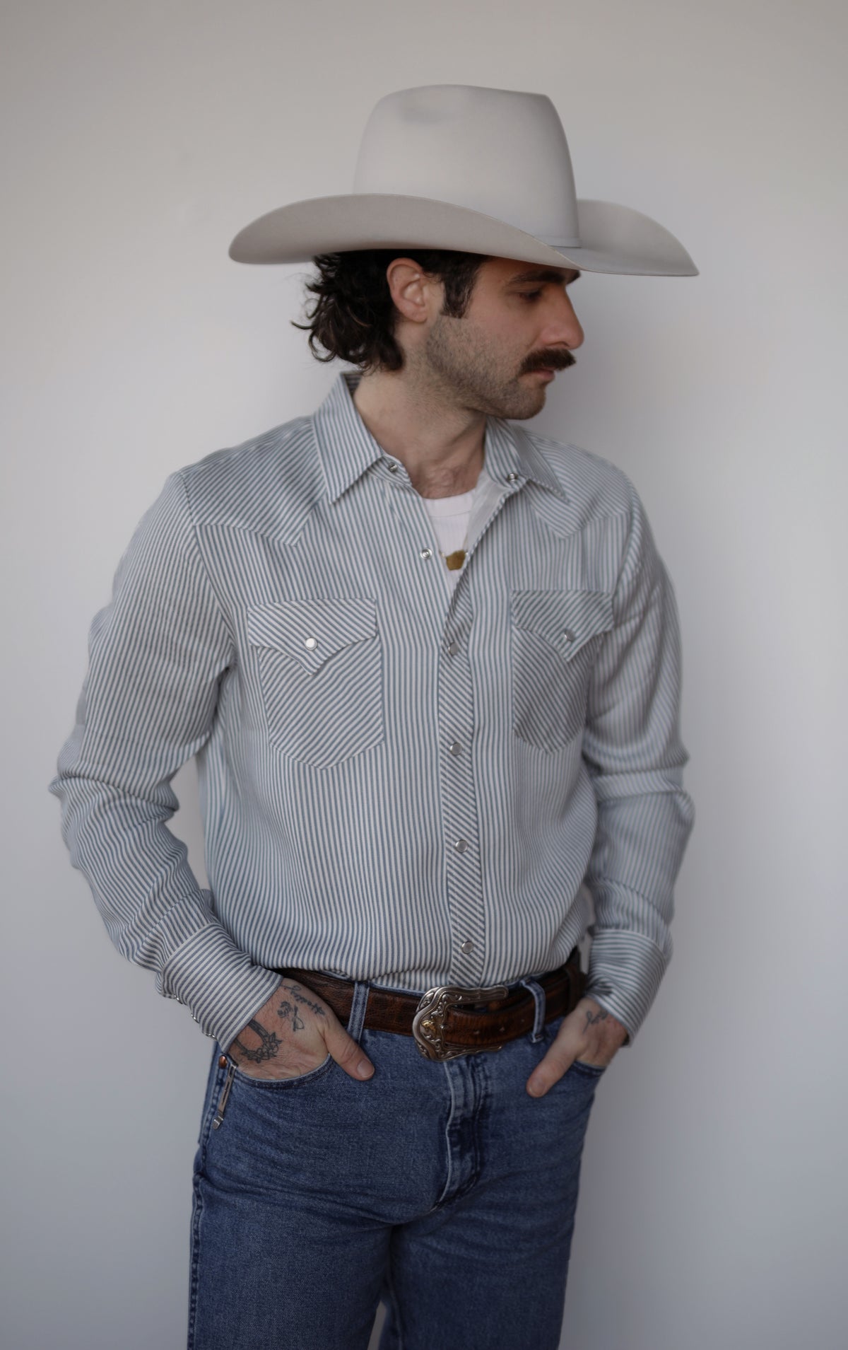 Three-quarter view of the H Bar C Folsom men's striped western shirt with pointed pocket flaps.