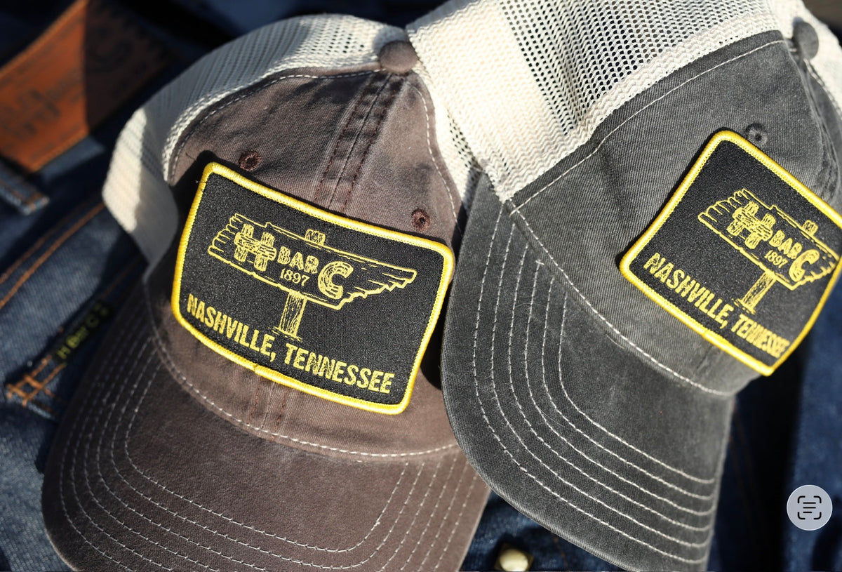 Two H Bar C Nashville, Tennessee signpost mesh trucker hats in brown and grey.