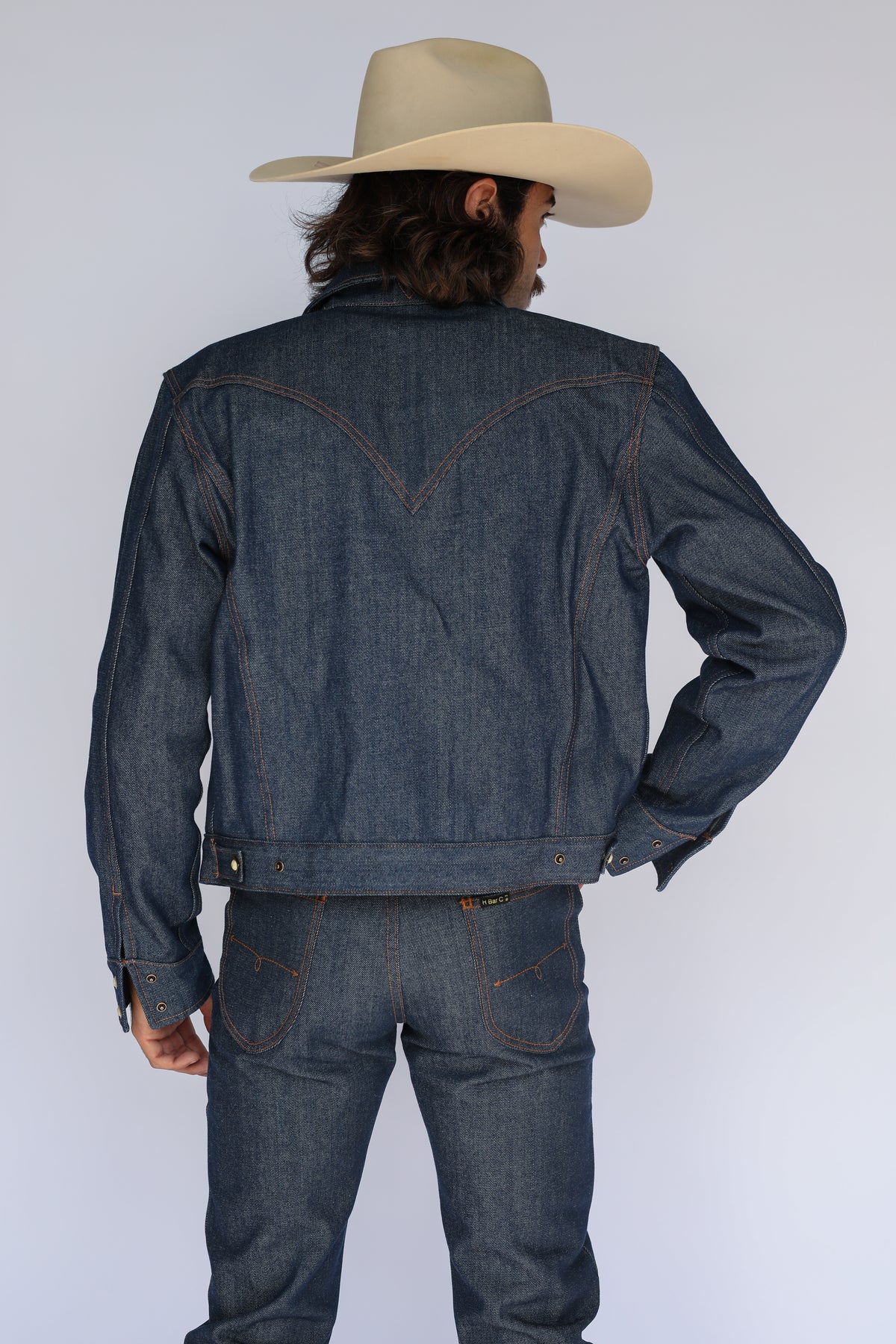 Back view of the H Bar C Salina indigo denim trucker jacket with matching raw denim jeans.
