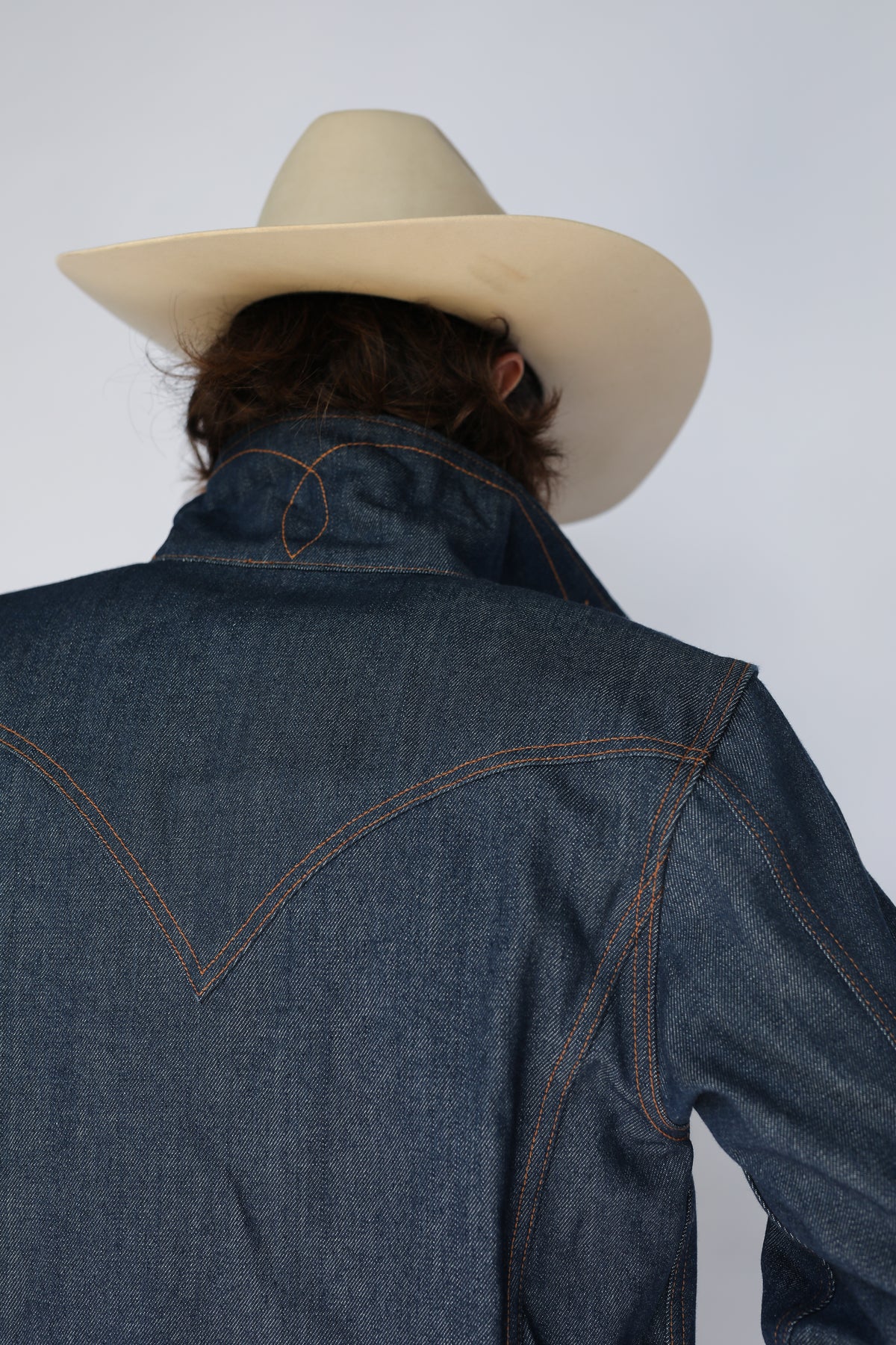 Back yoke detail of the H Bar C Salina indigo denim trucker jacket with contrast stitching.
