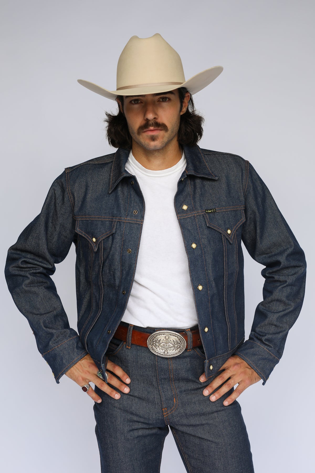 Man wearing the H Bar C Salina trucker jacket in indigo, a made in USA western denim jacket from American-grown cotton.