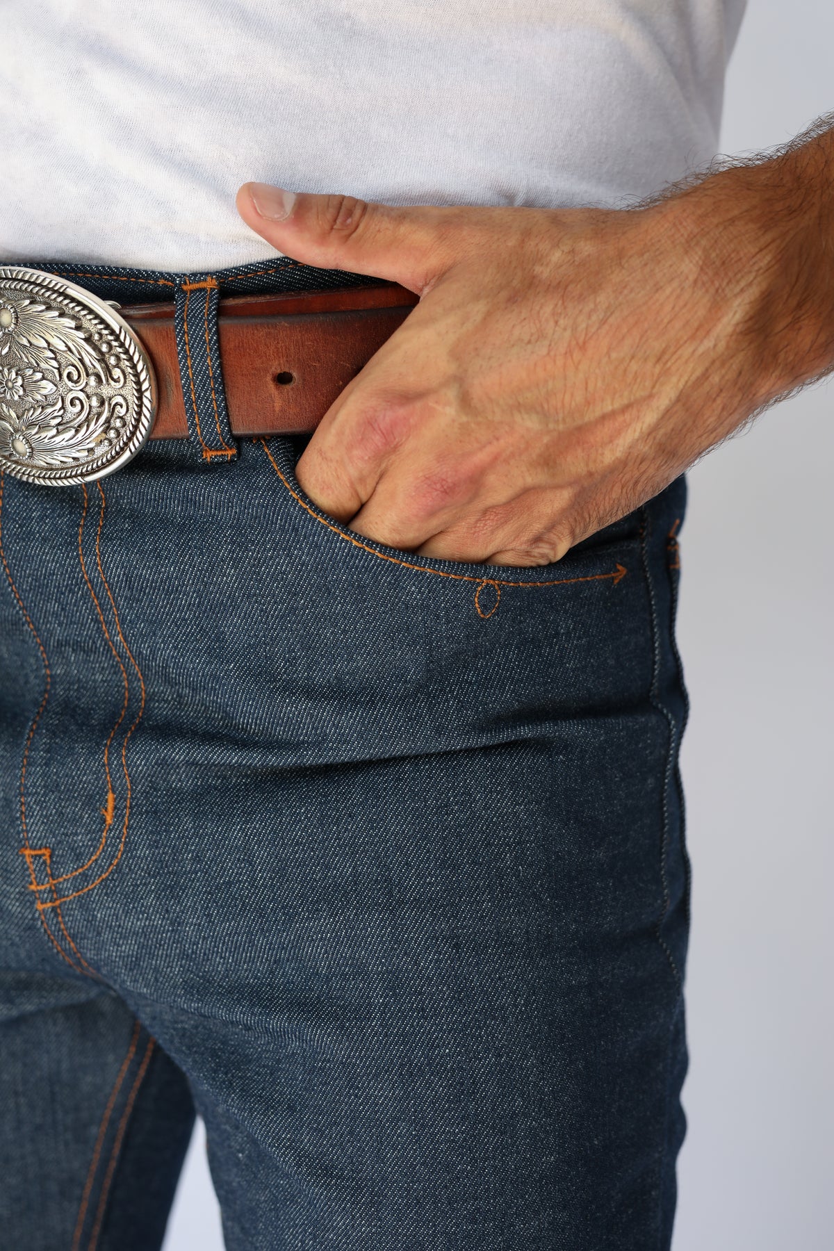 Front pocket and buckle detail of the H Bar C Boot Cut Flare raw indigo jeans.