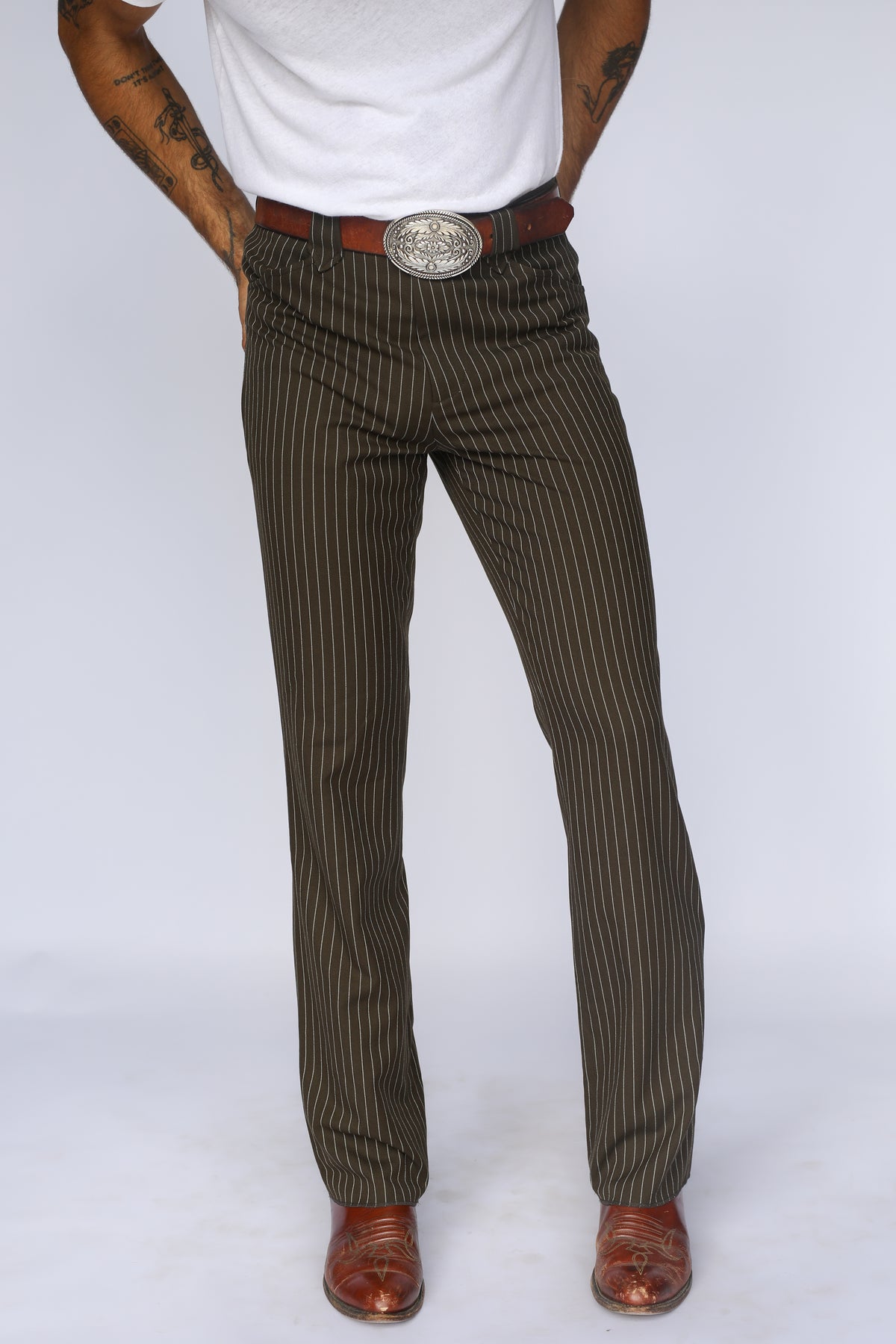 Front view of the H Bar C Bakersfield brown pinstripe pants with straight leg over cowboy boots.