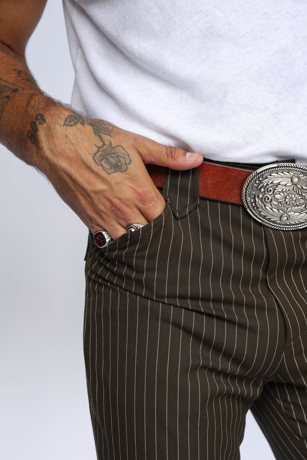 Close-up of the front pocket and silver buckle on the H Bar C Bakersfield brown pinstripe western pants.