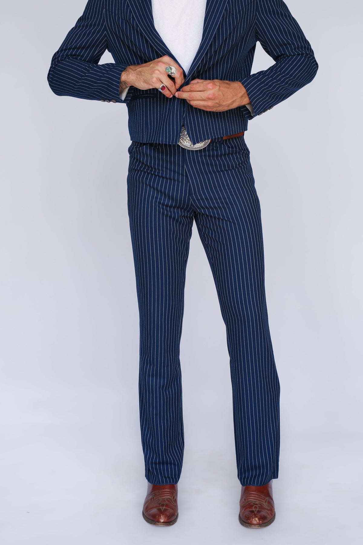 Front view from the shoulders down of the H Bar C Bakersfield navy pinstripe jacket and pants with brown boots.