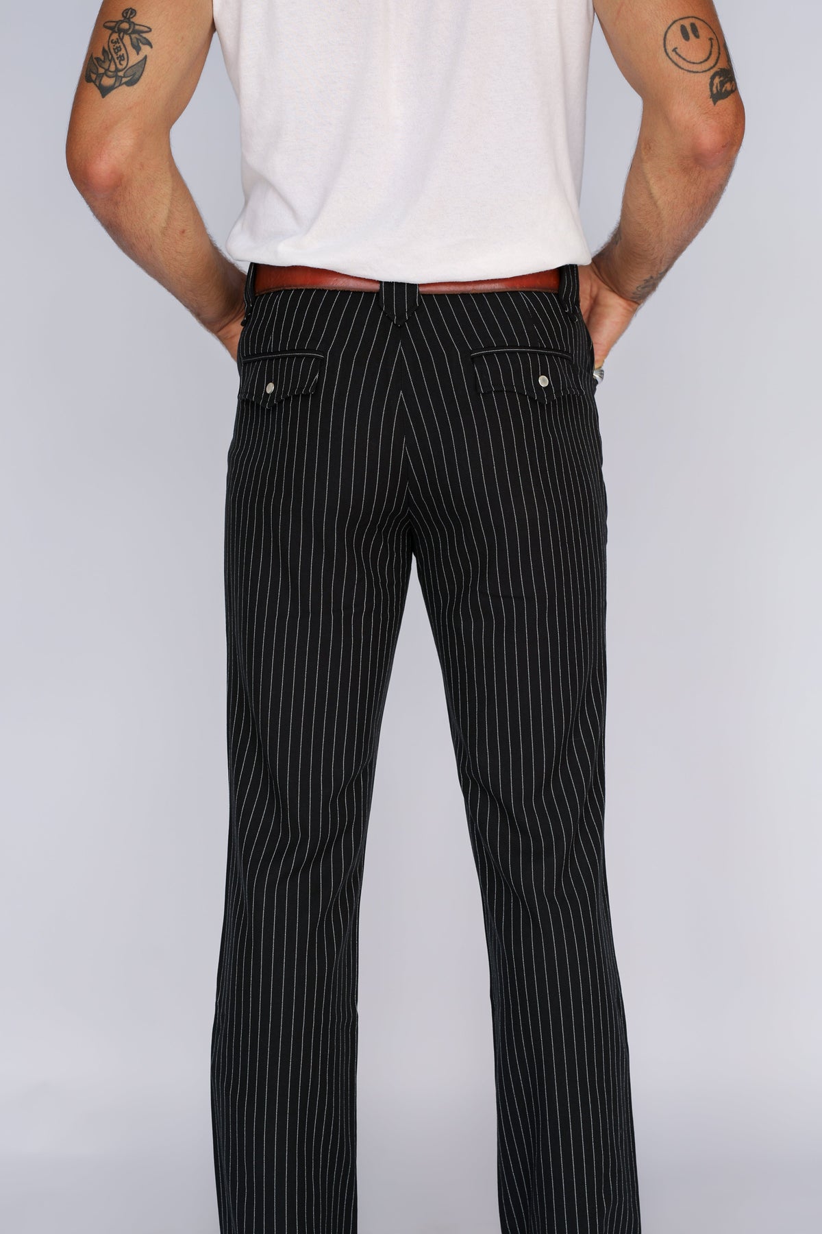 Back view of the H Bar C Bakersfield black pinstripe western pants from the waist down.