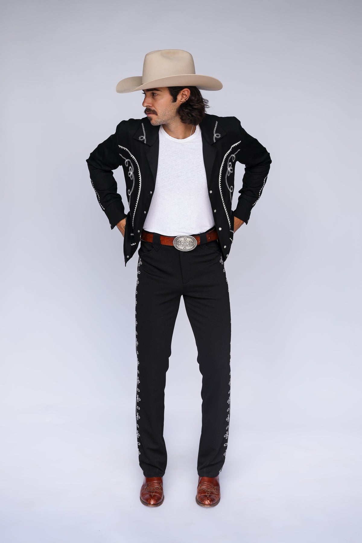 Full length view of the H Bar C Bolero black pants with embroidered side seams, styled with the matching Bolero jacket and cowboy hat.