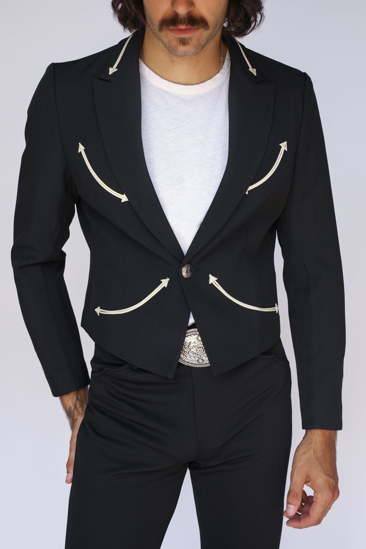 Front view of the H Bar C Calamity black western blazer with arrow-tipped smile pockets and lapel details over a white tee.
