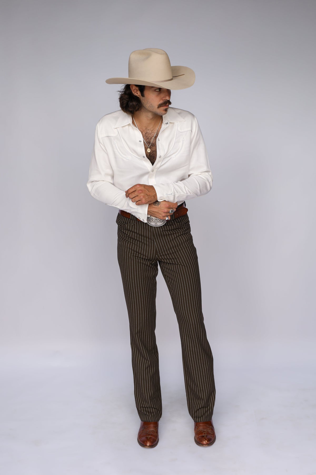 Full length view of the H Bar C Reno white western shirt with pinstripe pants and boots.