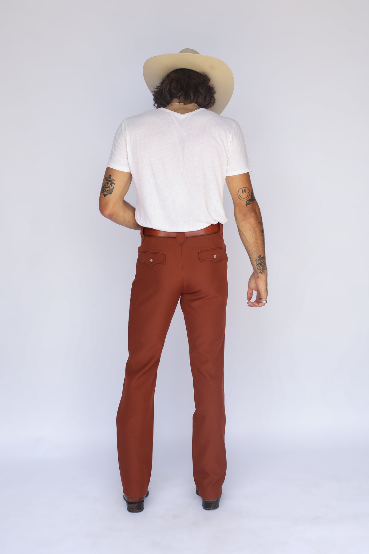 Full back view of the H Bar C Franklin brown western pants with cowboy hat.