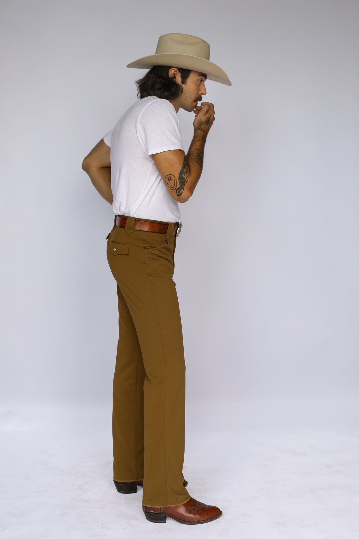 Side view of the H Bar C Franklin olive pants with a straight leg over cowboy boots.