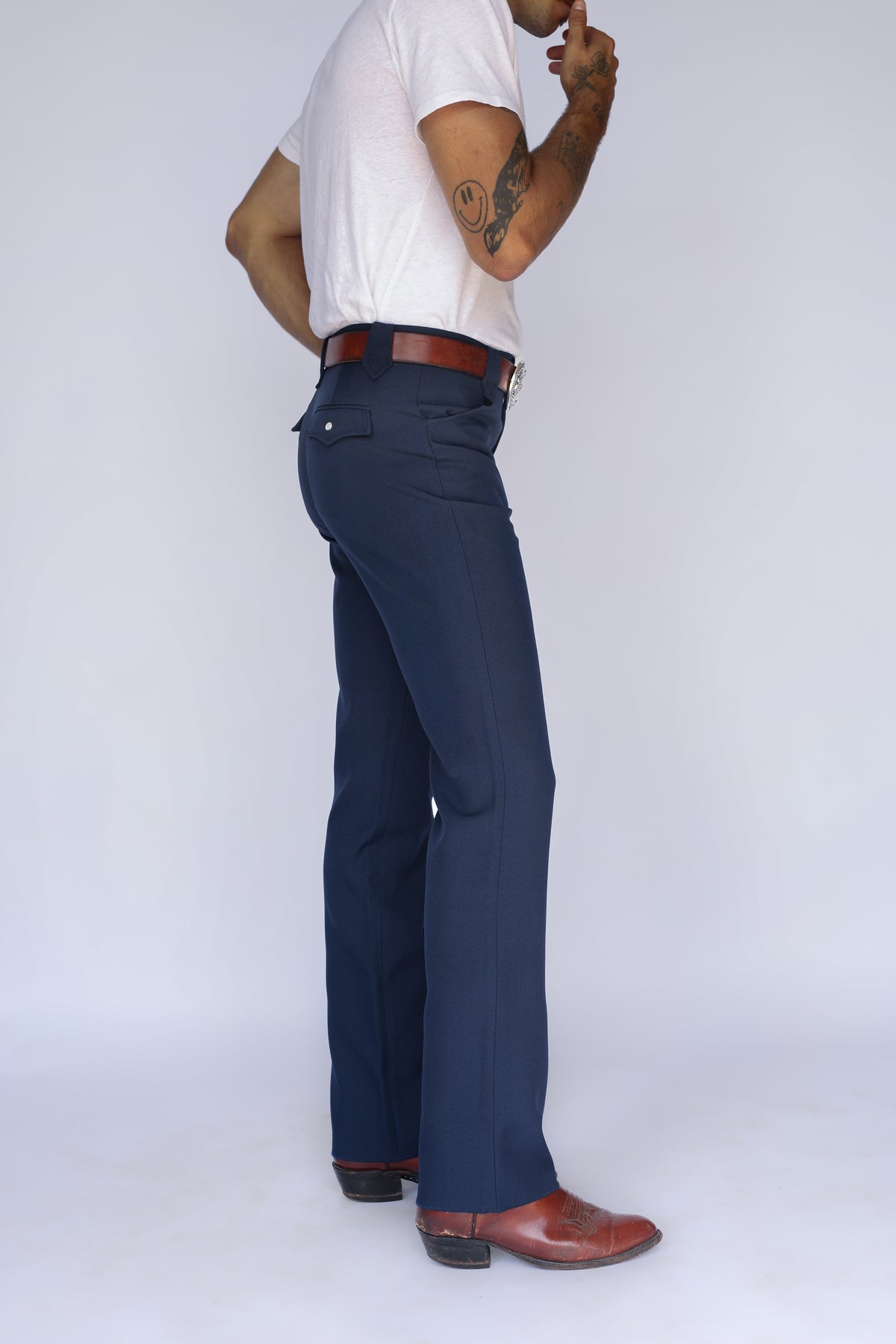 Side view of the H Bar C Franklin unisex western pants in navy, a stretch western dress pant, worn with cowboy boots.