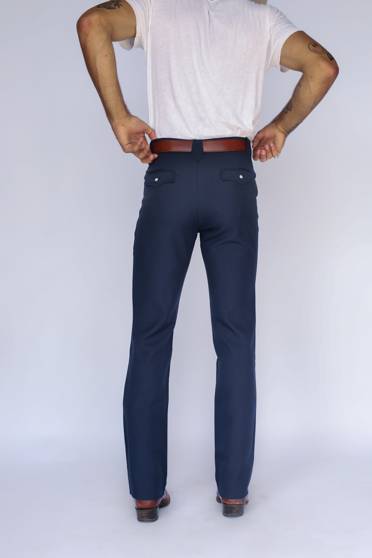 Back view of the H Bar C Franklin navy unisex western pants from the waist down.