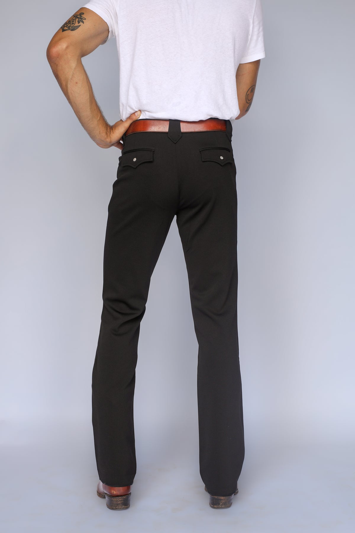 Back view of the H Bar C Franklin unisex black western pants showing the straight leg fit and flap back pockets.