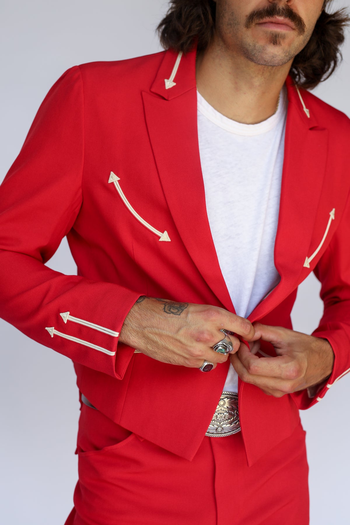 Close-up of the button and cream arrow pockets on the H Bar C Calamity men's red jacket.