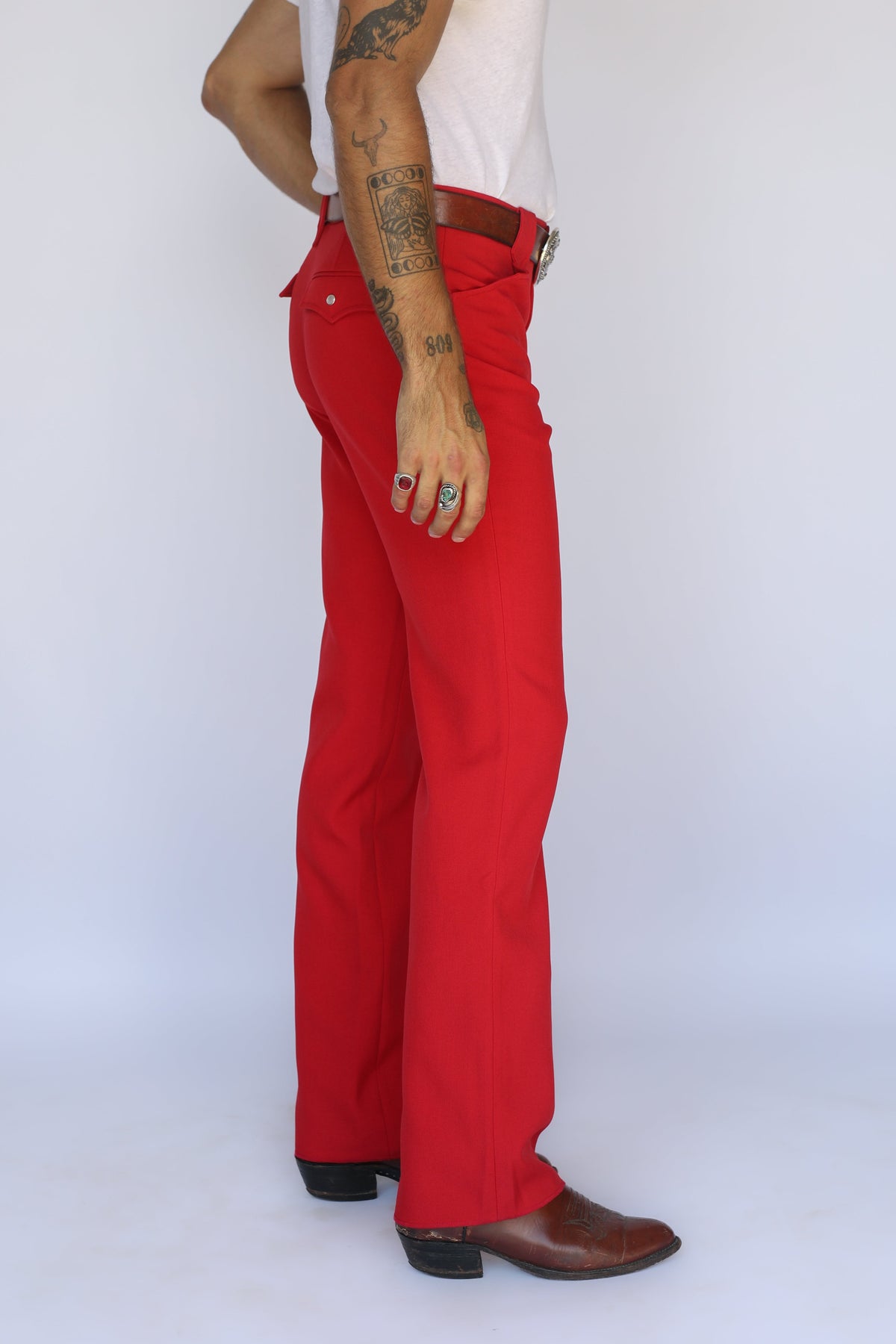 Side view of the H Bar C Franklin red western pants with a straight leg over cowboy boots.