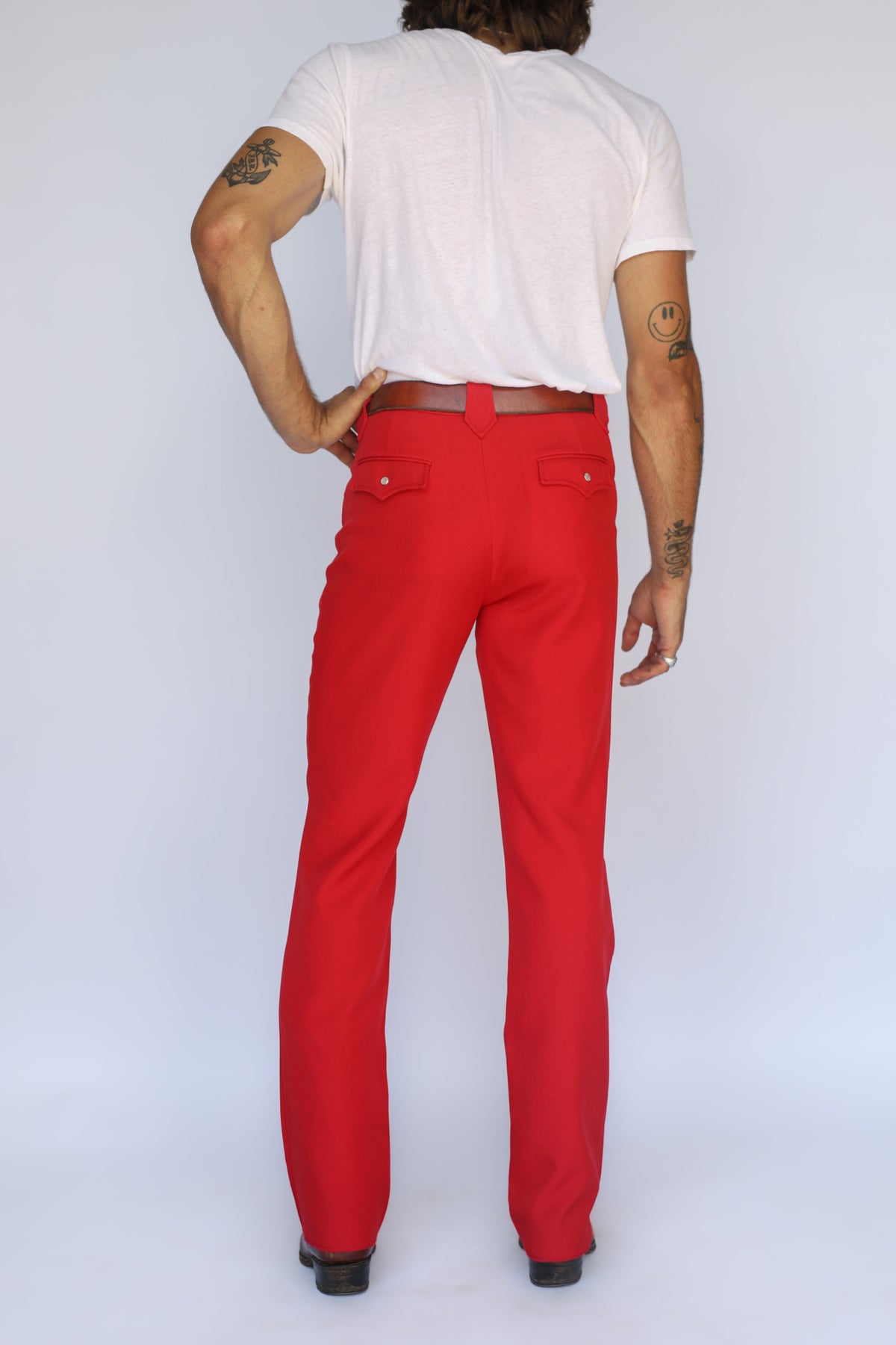 Back view of the H Bar C Franklin unisex red western pants with a white tee and brown belt.