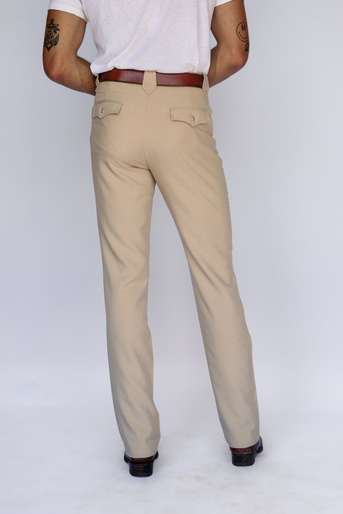 Back view of the H Bar C Calamity tan western pants from the waist down.