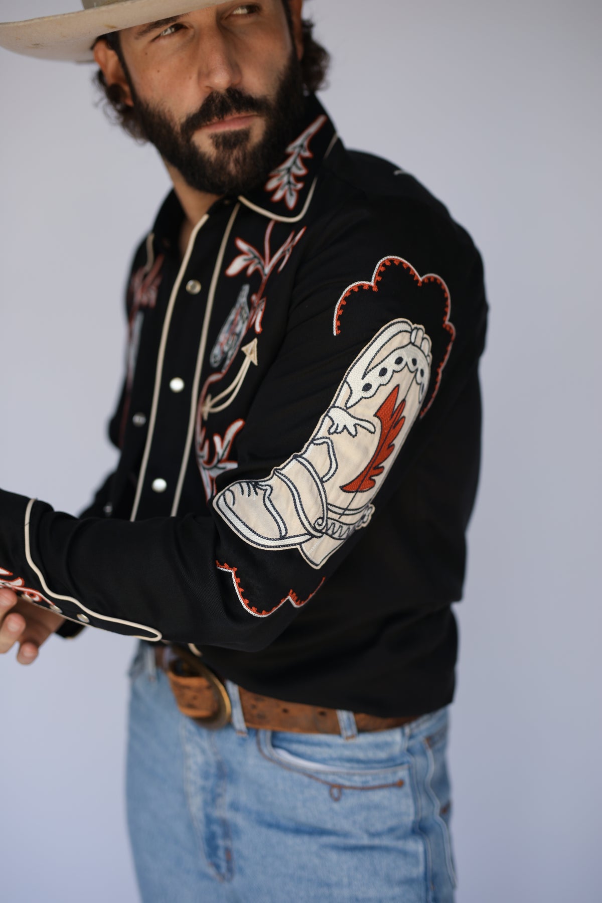 Sleeve detail of the chain stitch cowboy boot embroidery on the H Bar C Calabasas black shirt.