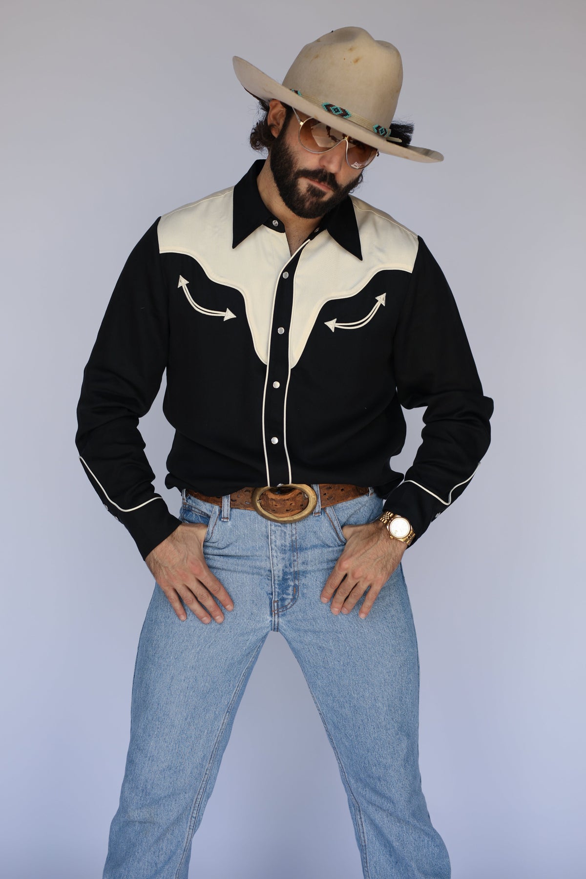 Man in a cream cowboy hat wearing the H Bar C San Juan men's shirt in black with cream yokes and piping, a classic 1940s style western shirt, with light jeans.