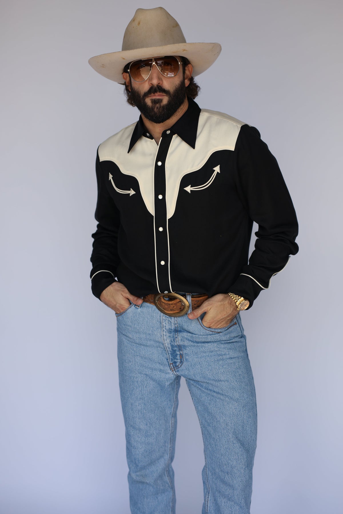 Front view of the H Bar C San Juan black shirt with cream yoke, smile pockets, and pearl snaps, worn with a cowboy hat and jeans.