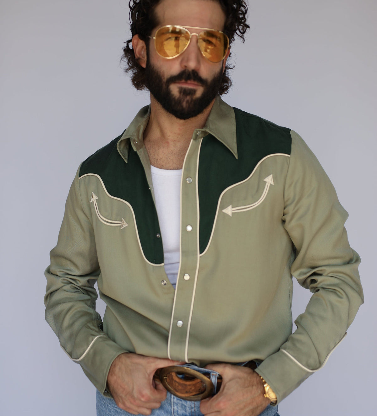 Front view of the H Bar C San Juan men's shirt in green with contrast yoke, worn with gold aviator sunglasses and jeans.
