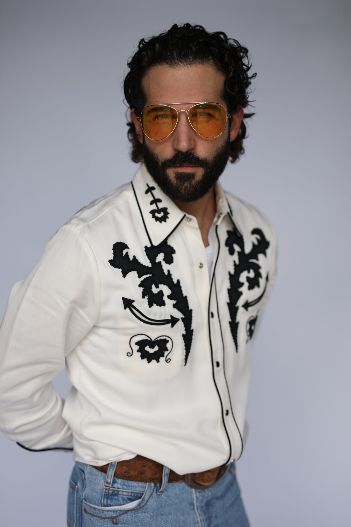 Man in tinted sunglasses wearing the H Bar C Dali white embroidered western shirt.