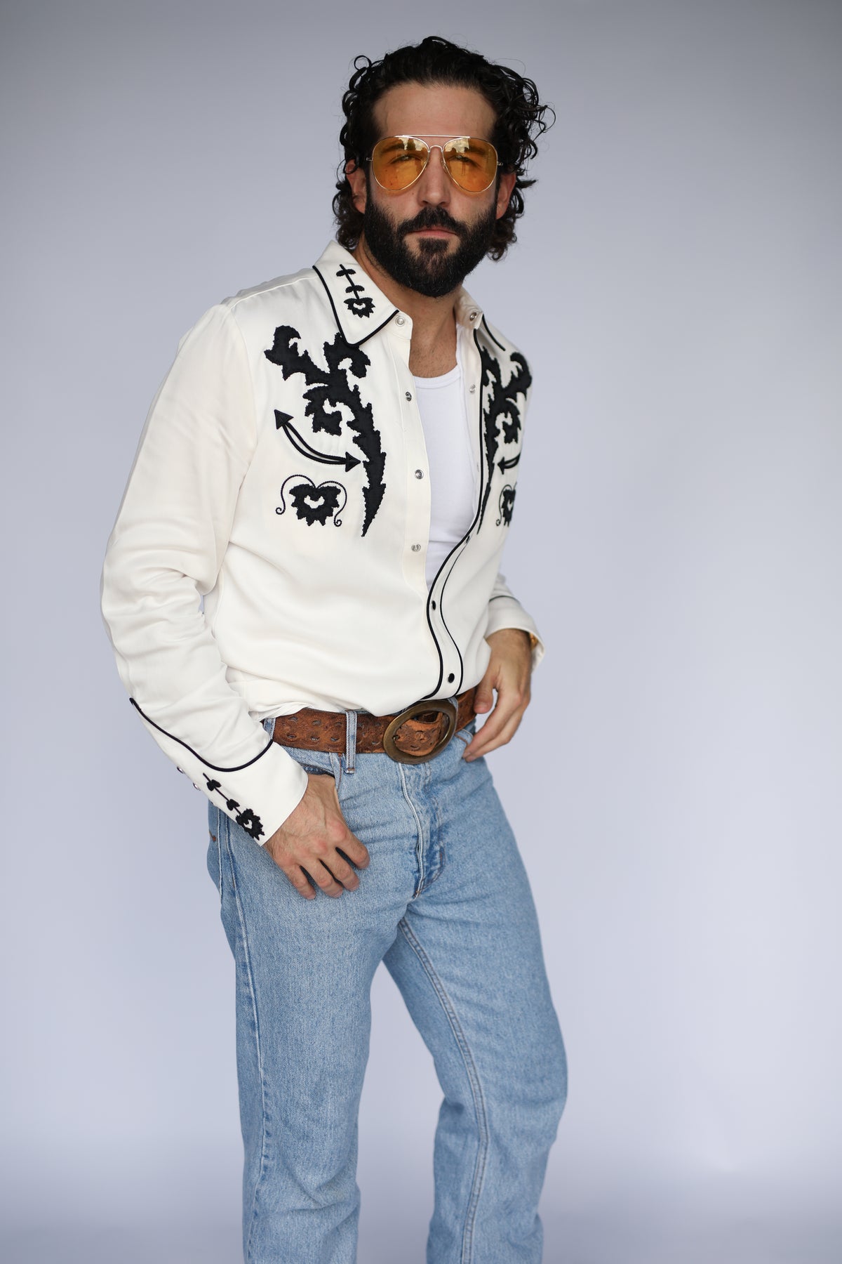 Three-quarter view of the H Bar C Dali white shirt tucked into jeans.