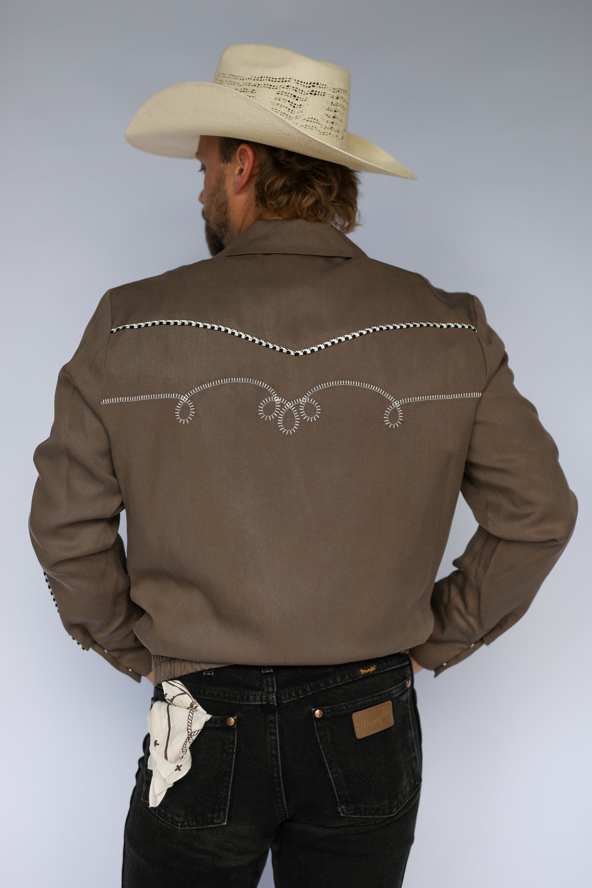 Back view of the H Bar C Bolero cocoa and white jacket with embroidered back yoke.