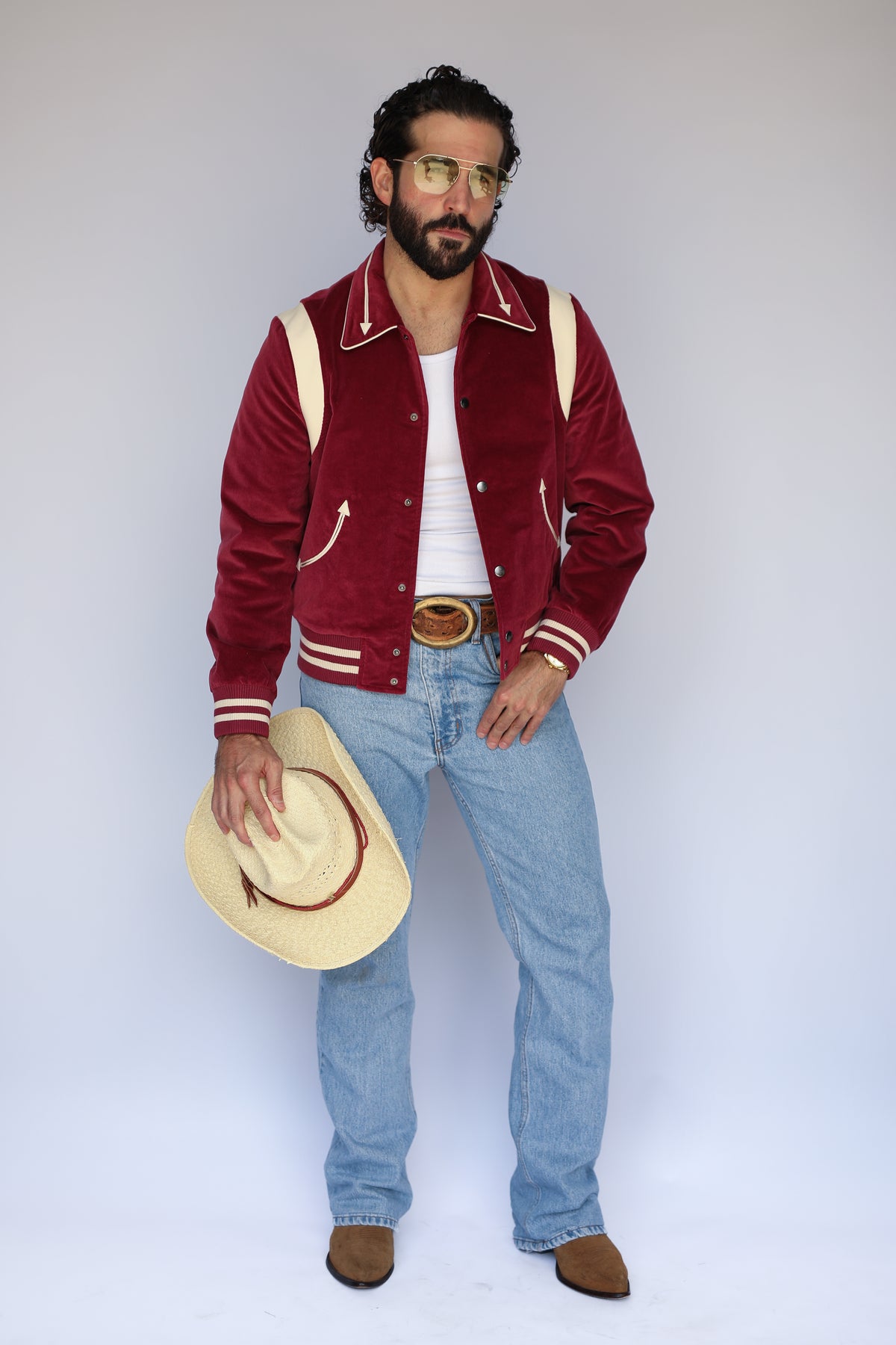 Full length view of the H Bar C Silver Lake maroon corduroy jacket with striped ribbing and jeans.