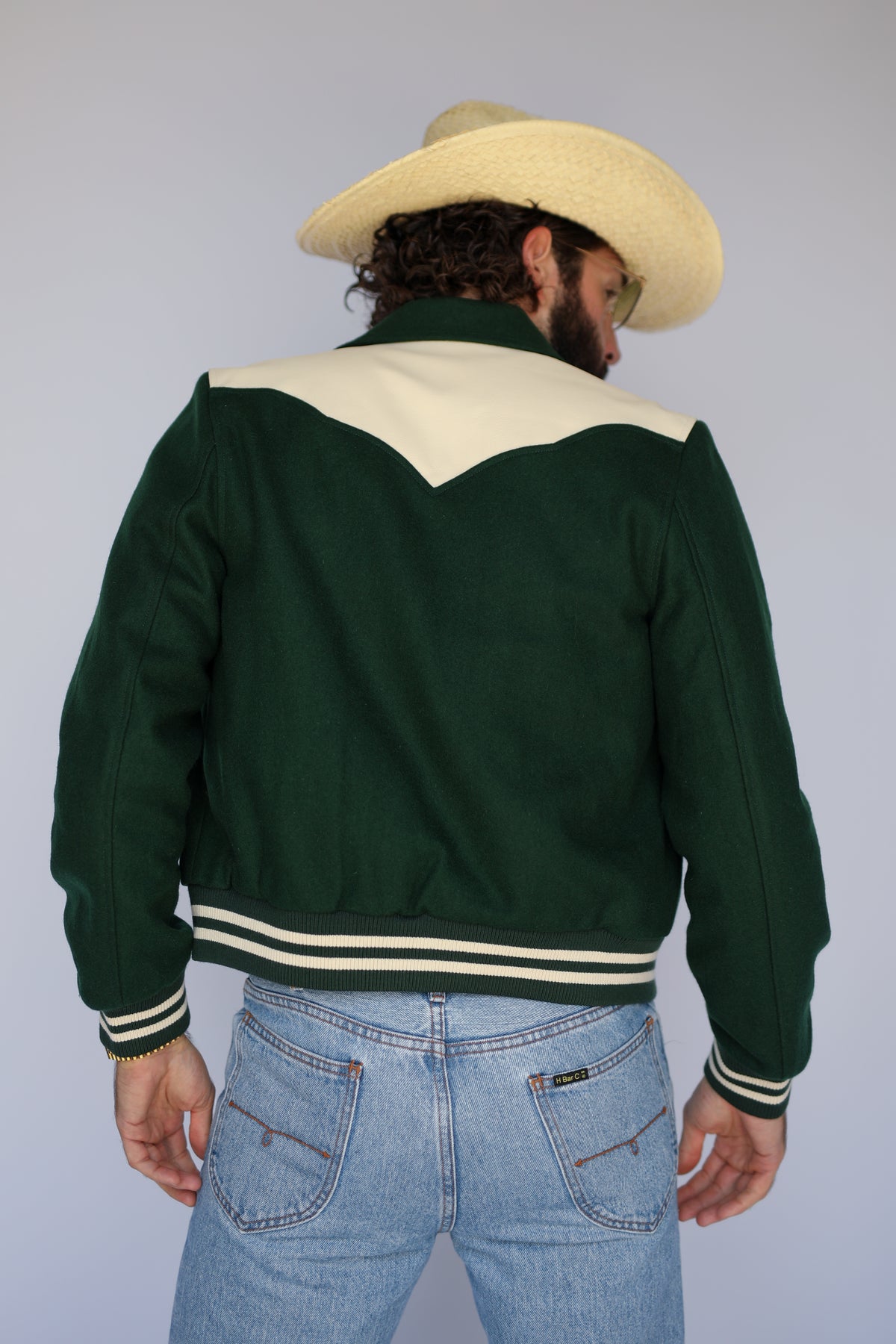 Back view of The Vail green jacket by H Bar C with cream back yoke and striped hem.