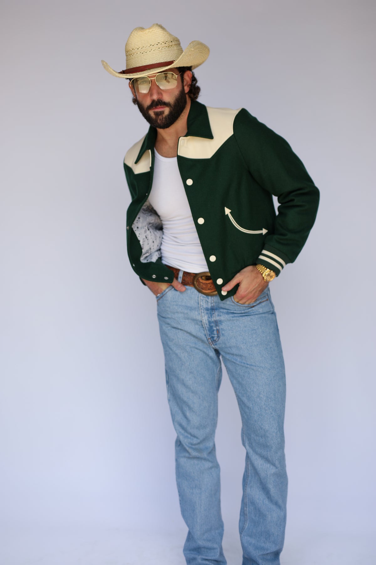 Side view of The Vail H Bar C green wool western jacket with jeans.