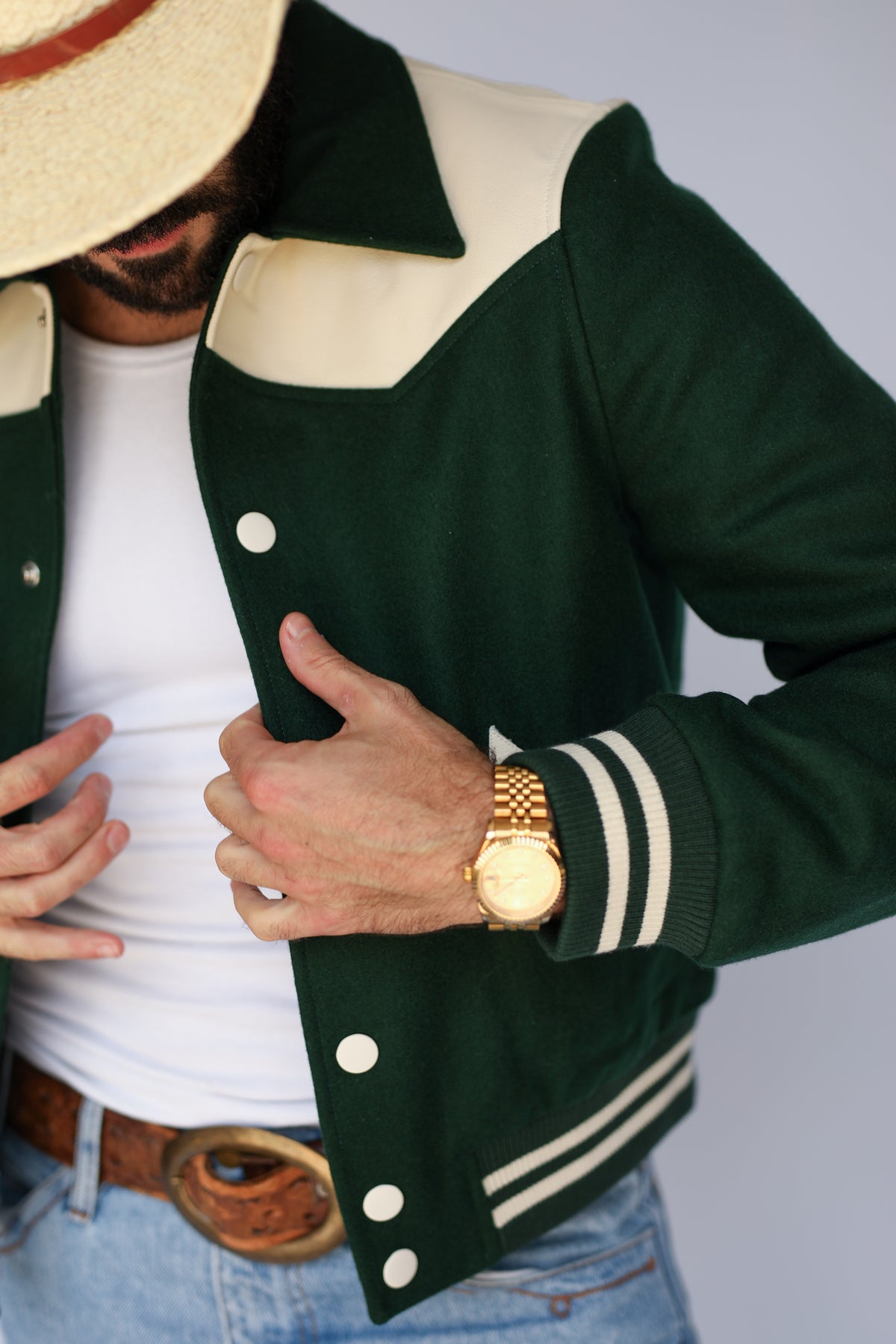 Detail of the snap front and striped cuff on The Vail H Bar C green jacket.