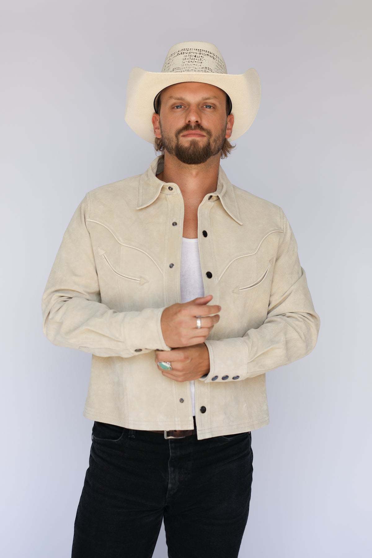 Man in a cream cowboy hat wearing the H Bar C Austin jacket in stone suede, cut from an H Bar C archival pattern.