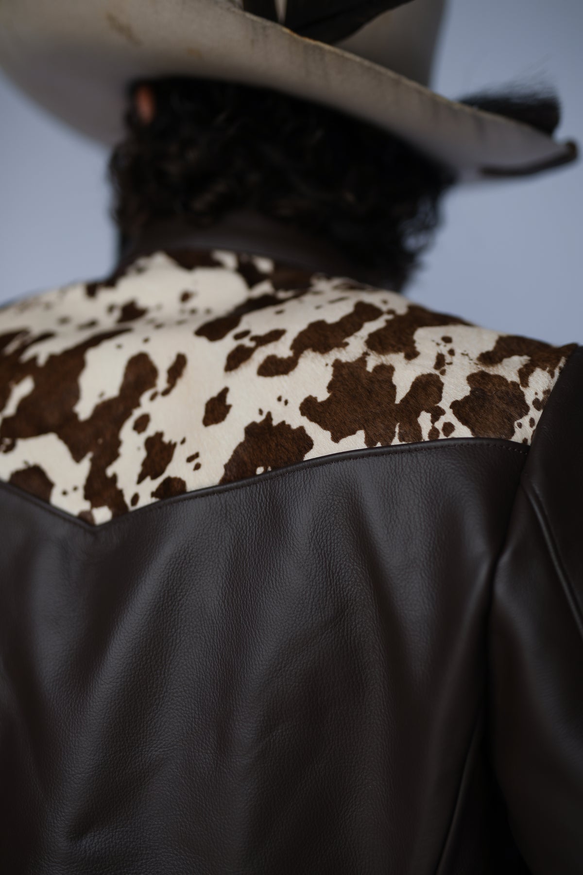 Detail of the brown and white cowhide back yoke on the H Bar C Cody jacket.