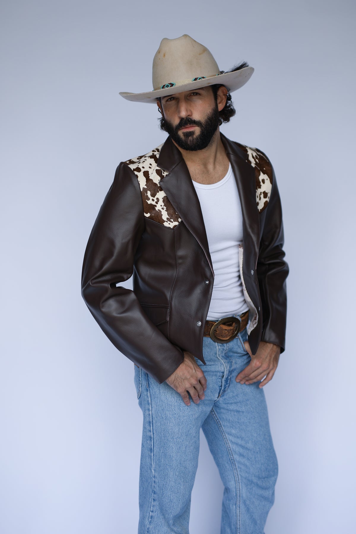 Man in the H Bar C Cody brown leather jacket and cream cowboy hat.