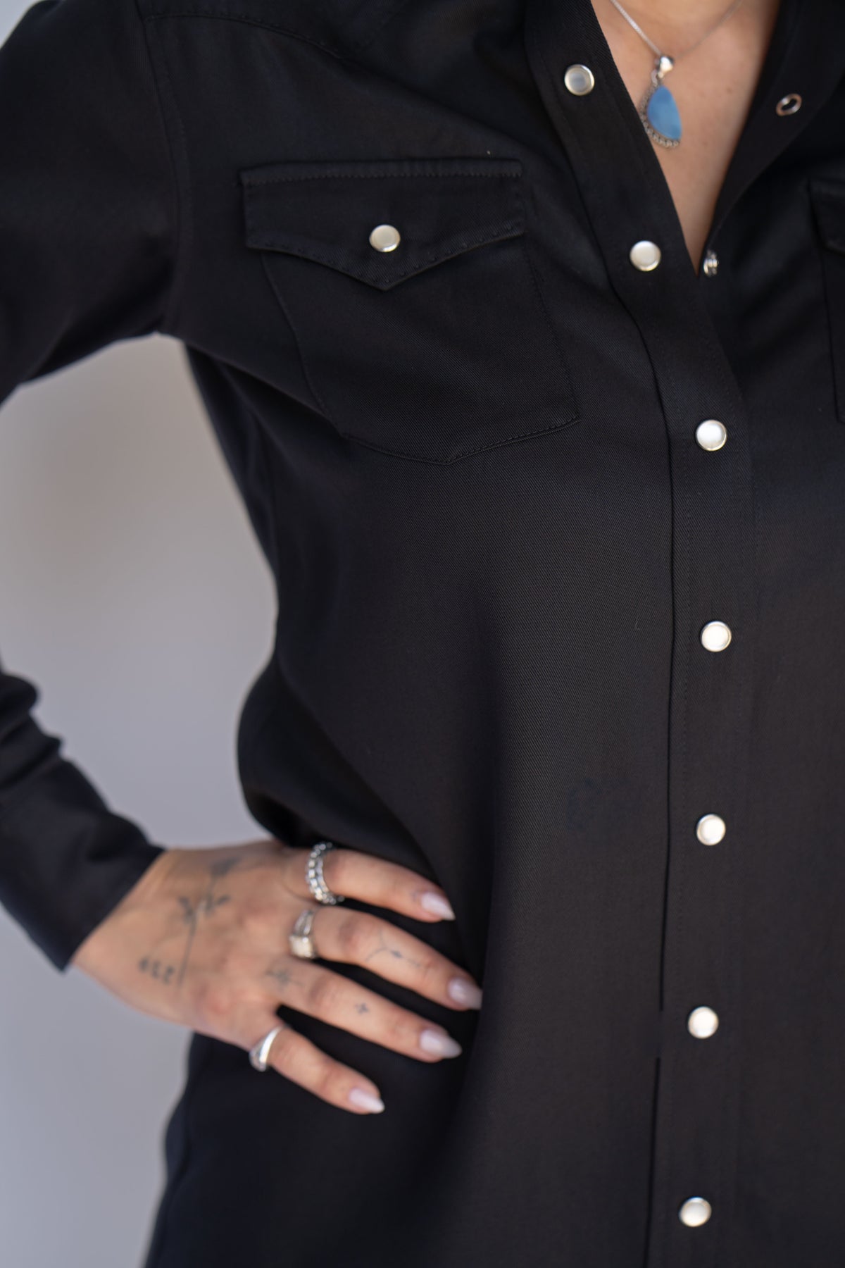 Chest pocket and pearl snap placket detail on the H Bar C Savannah women's black western shirt dress.