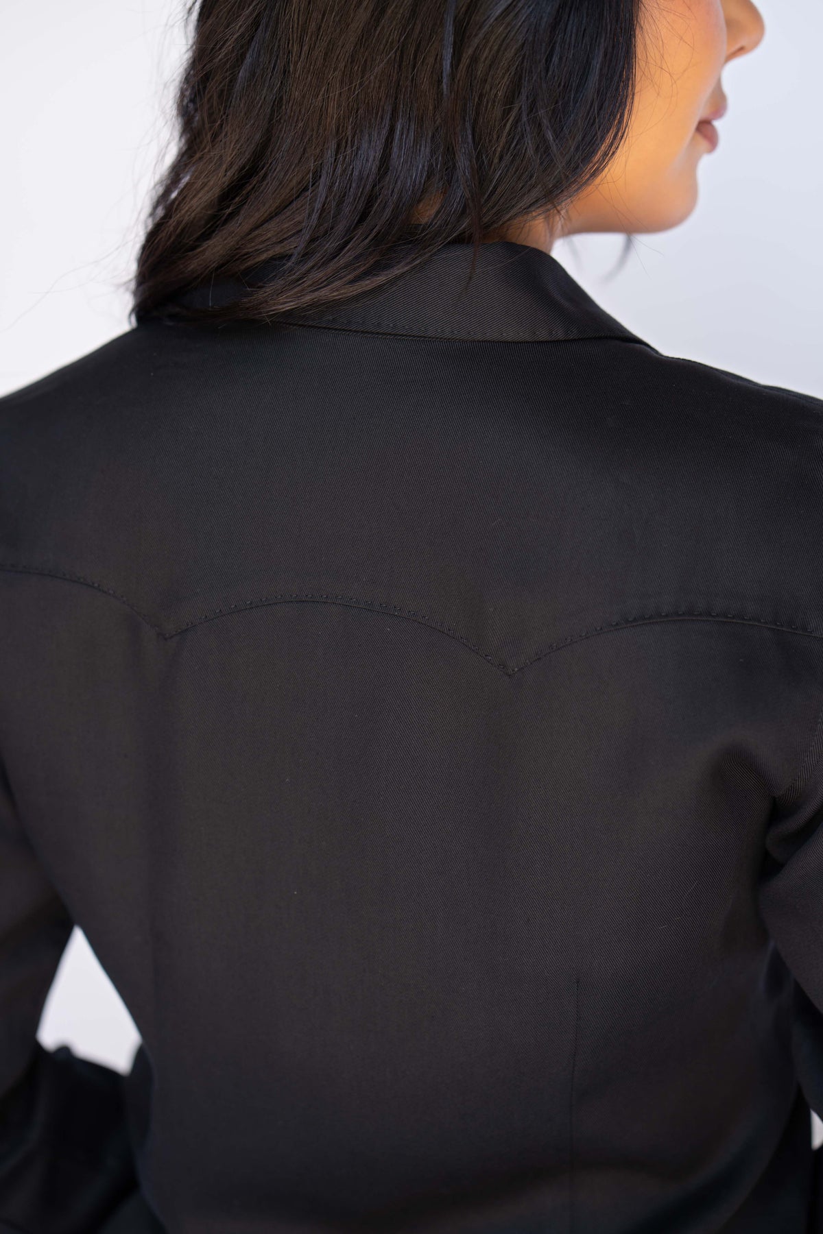 Back yoke detail of the H Bar C Savannah black dress showing the classic western shirt yoke on black Tencel.