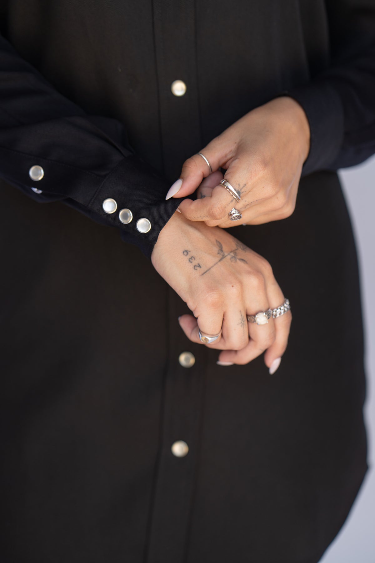 Close-up of the pearl snap cuffs on the H Bar C Savannah women's black western shirt dress.