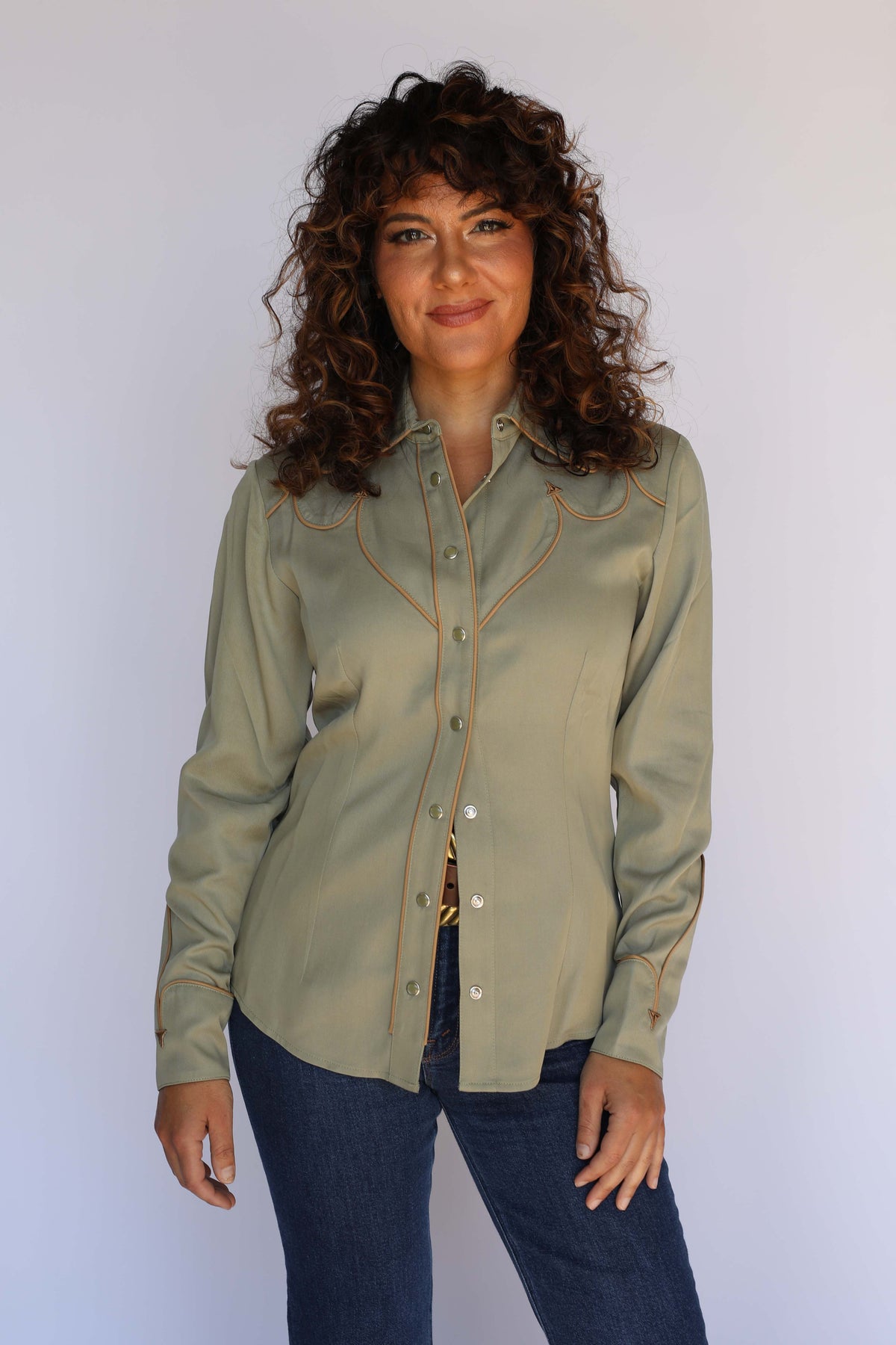 Woman wearing the H Bar C Lake Tahoe women's western shirt in olive green tucked into jeans with a gold buckle, vintage inspired western wear.