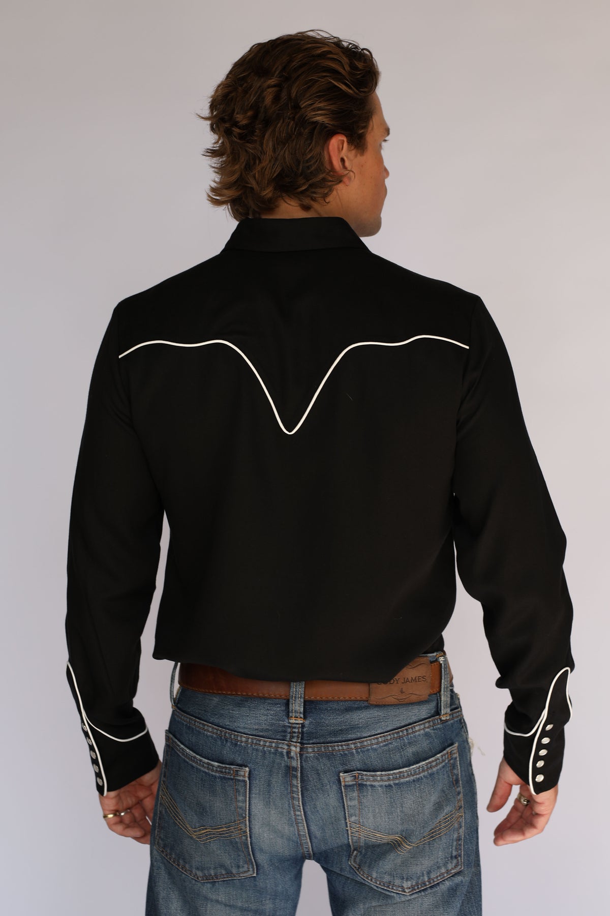 Back view of the H Bar C San Fernando men's black shirt with white piped back yoke and cuffs, classic vintage western wear.