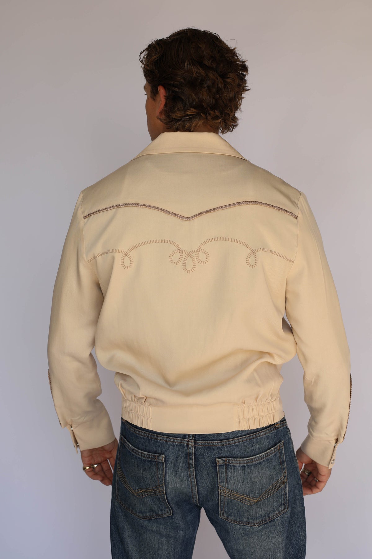 Back view of the H Bar C Bolero beige jacket with embroidered back yoke.