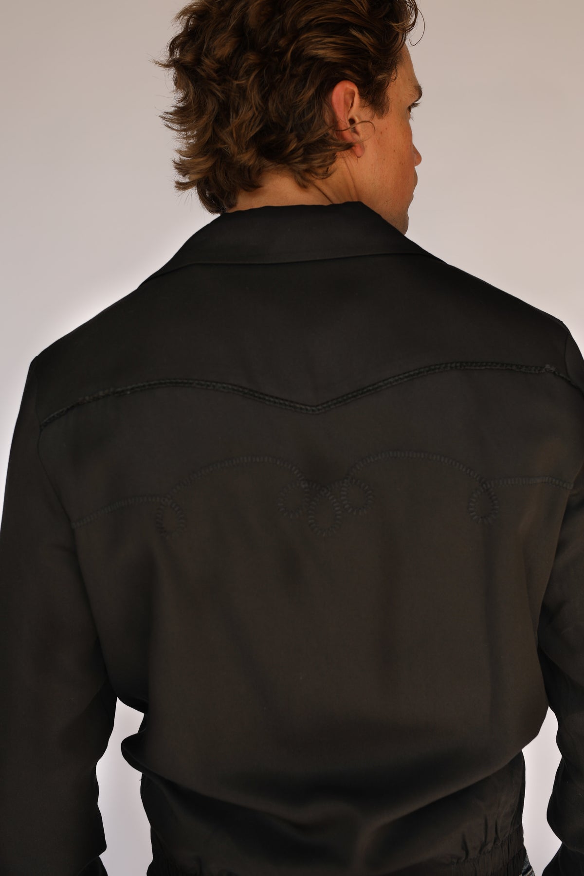 Close-up of the black chain stitch back yoke on the H Bar C Bolero black on black jacket.