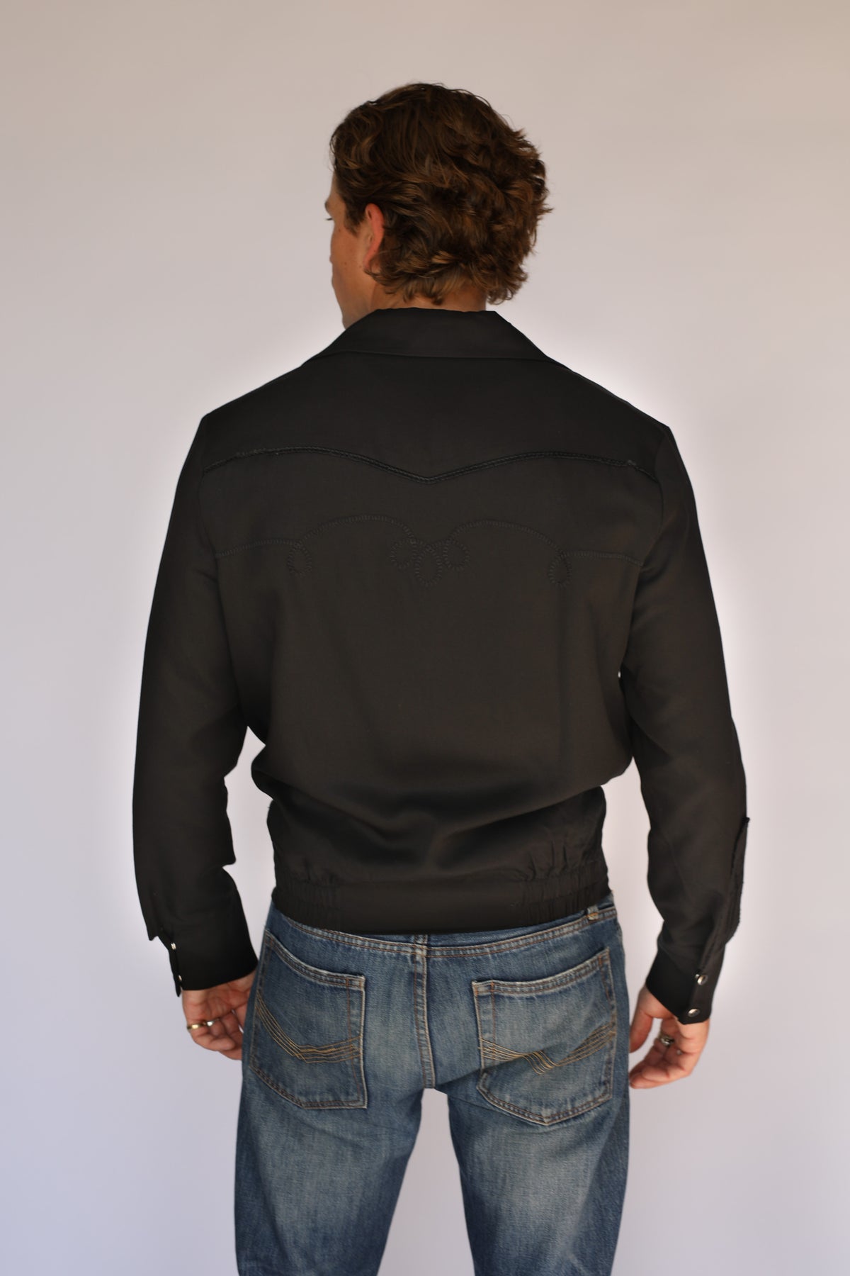 Back view of the H Bar C Bolero black on black jacket with tonal embroidered back yoke.