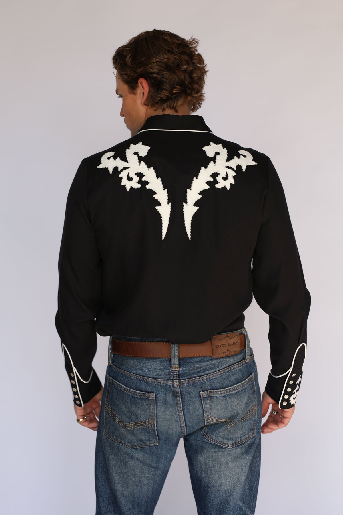 Back view of the H Bar C Dali western shirt in black with large white embroidered back yoke.